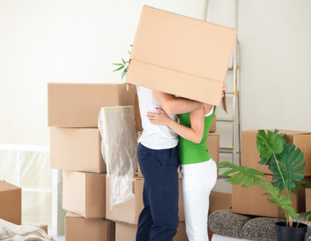 Packed household boxes and protected furniture ready for transport